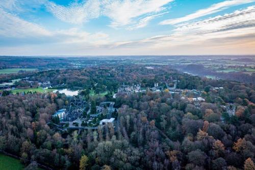 an aerial view of a castle in a forest at Throwley, woodland lodge with hot tubs for 14 in Oakamoor