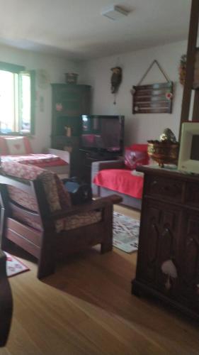a bedroom with two beds and a chair in it at Un NIDO tra i monti in Piancavallo