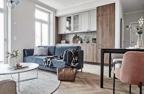 a living room with a blue couch and a table at Villa Esperance - Suite Céleste mit Balkon, Dampfbad Whg 10 in Binz