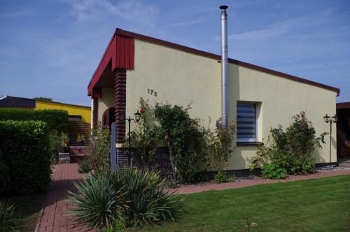 a white building with a red roof at Ferienhaus Ostseebodden in Sundhagen