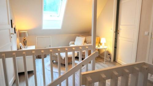 a staircase leading to a living room with a couch at Landhaus Måsberget in Kristinehamn