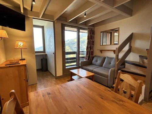 un salon avec un canapé et une table dans l'établissement Duplex rénové au pied des pistes à Méribel, 7 couchages - FR-1-355-233, à Les Allues