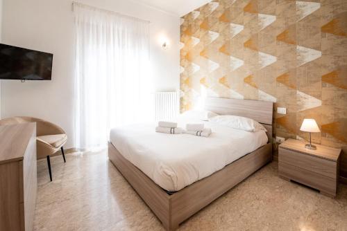 En eller flere senge i et værelse på Appartamenti Ferdi - Trilocale o Mansarda