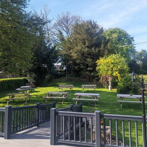 a bunch of picnic tables in a park at The Duke Hotel in Hilmarton