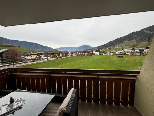 a balcony with a view of a green field at ApartmentAvenue in Kaprun