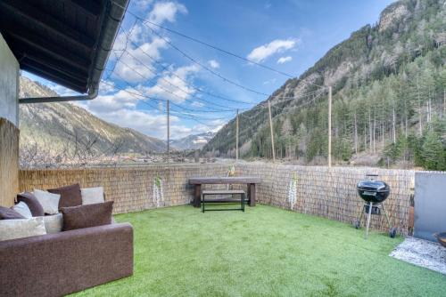a patio with a table and a grill on a brick wall at Sweet Home Apartments in Tösens