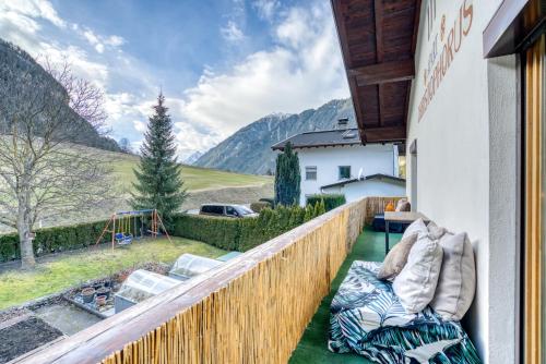 a balcony with chairs and a view of mountains at Sweet Home Apartments in Tösens