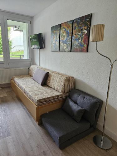 a living room with a couch and a lamp at Gipfelfreund 2 in Sankt Englmar