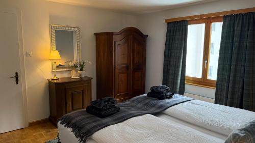 a bedroom with a bed with black towels on it at Chalet Apt Melesez in Zermatt