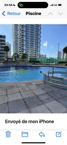 a screenshot of a picture of a pool with buildings at Bel appartement Dubai marina in Dubai