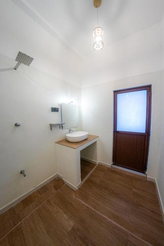 a bathroom with a sink and a mirror at Bluesafiya lodge in Matara