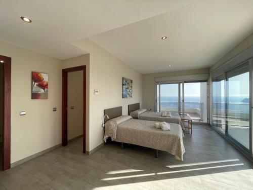 a bedroom with a bed and a view of the ocean at Apartamentos Entremares - Grupo Antonio Perles in Calpe