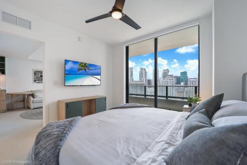 a bedroom with a bed and a large window at New unit 28th Floor with Unbeatable Bayside Views in Miami