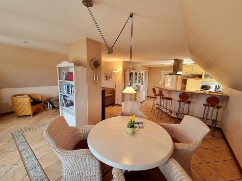 Una cocina y una sala de estar con mesa y sillas. en Landtraum, en Oevenum