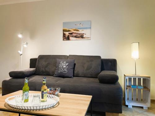 a living room with a couch and a table at Fischerhuus Whg 3 in Wyk auf Föhr