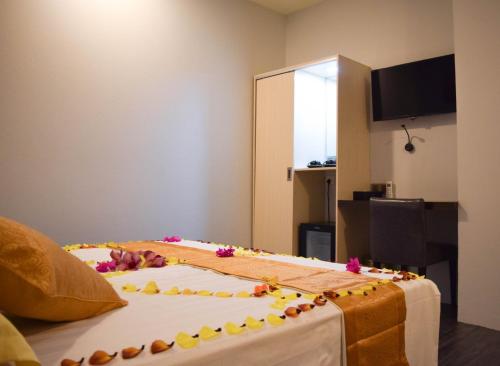 a cake on top of a bed in a room at Dhiffushi Tourist Hotel in Dhiffushi