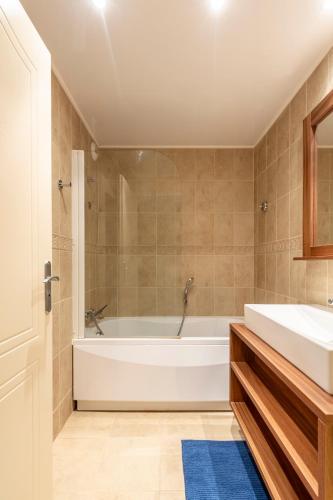 une salle de bain avec une baignoire et un lavabo dans l'établissement Joli T2, Centre, Parking privé, Wifi, Local à ski, à Isola 2000