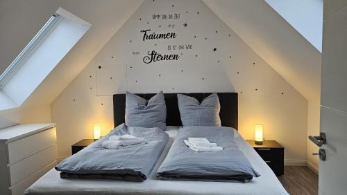 a bedroom with a bed with two pillows at Haus Ilse Wohnung 9 in Sankt Andreasberg