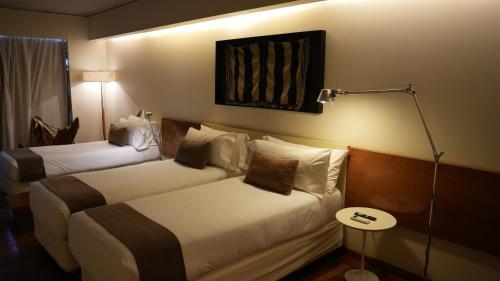 Ένα ή περισσότερα κρεβάτια σε δωμάτιο στο Design Suites Salta