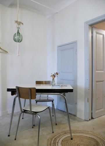 une salle à manger avec une table et deux chaises dans l'établissement Charmante suite indépendante en maison de village, à Loriol-sur-Drôme