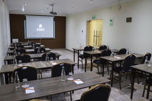 a room with tables and chairs and a projection screen at Rado Hotel - Quintanas in Trujillo