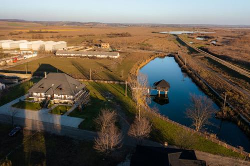 an aerial view of a large house next to a river at Casa Andra in Siret
