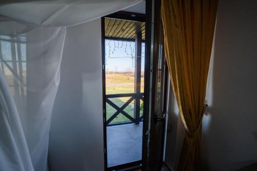 a door to a room with a view of a window at Casa Andra in Siret
