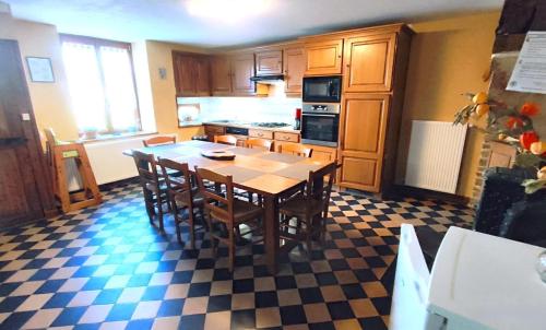 a kitchen with a table and chairs in a room at Chez leontine in Puilly-et-Charbeaux