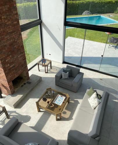 a living room with couches and a table and a pool at Casa Tullpa in Aspitia