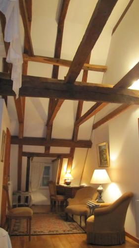 a living room with wooden ceilings and wooden beams at Château Porthos Tranquillité des Pyrénées in Lanne en Barétous