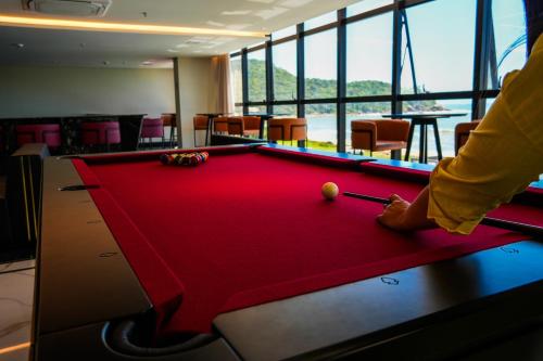 a man playing pool in a room with a pool table at Blue Sea Hotel in Itapema