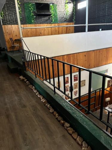 a stairwell in a building with a fence and rocks at Hosteria Cerros Dorados in Cosquín