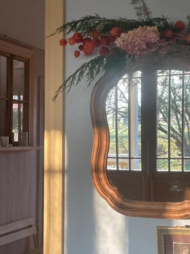 a mirror hanging on a wall with a window at Ielejas A place for cool living in Vircava