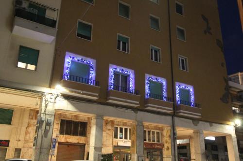 a building with purple lights on the windows at La Dolce Vita Civitavecchia in Civitavecchia