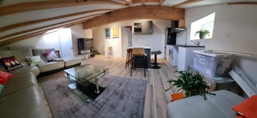 a large living room with a couch and a table at Montelly in Crassier