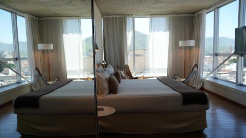 Ένα ή περισσότερα κρεβάτια σε δωμάτιο στο Design Suites Salta
