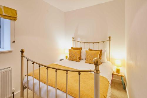 a bedroom with a bed with yellow sheets and pillows at Host & Stay - Temple Terrace in Richmond