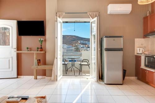 a kitchen with a door open to a patio with a table at Marbil Irida Kythnos in Mérikhas