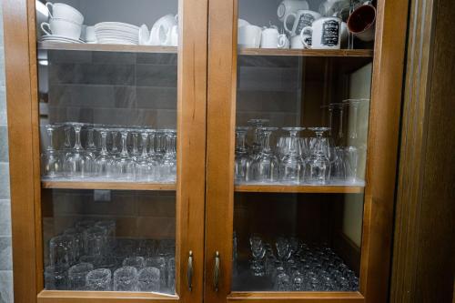 a glass cabinet filled with glasses and plates at Casa Andra in Siret