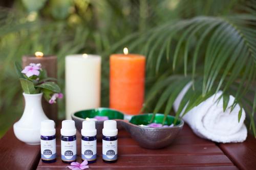 a table with several bottles of essential oils and candles at Mara Leisure Camp in Talek