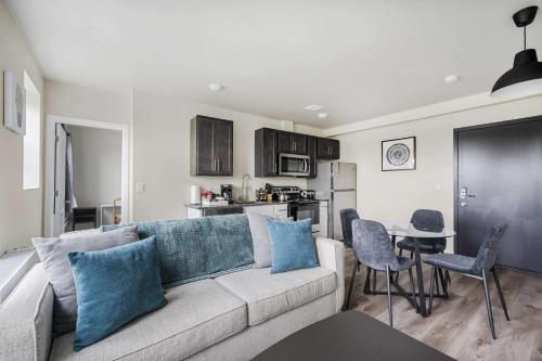 a living room with a couch and a kitchen at 2BR Luxury Suite Near Henry Ford in Detroit