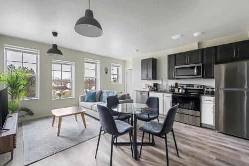 a kitchen and living room with a table and chairs at 2BR Luxury Suite Near Henry Ford in Detroit