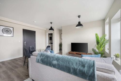 a living room with a couch and a tv at 2BR Luxury Suite Near Henry Ford in Detroit