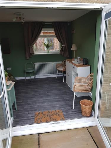 an open room with two chairs and a desk at Farsley guest room seperate entrance with double bedroom and private shower room in Farsley