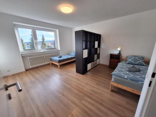 a bedroom with a bed and a bench in it at Elpke in Bielefeld