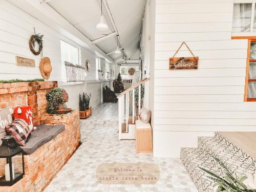 a hallway of a house with a brick wall at Little Latte House - Chalong in Ban Na Bon