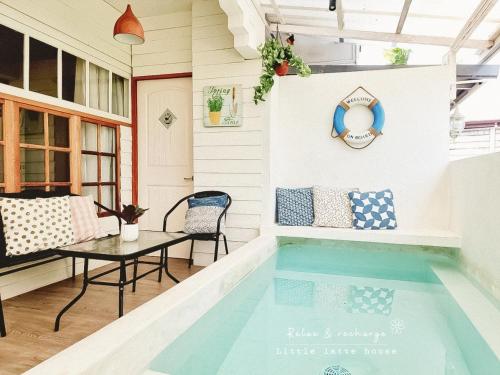a swimming pool in the middle of a house at Little Latte House - Chalong in Ban Na Bon