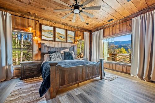 a bedroom with a bed and a ceiling fan at Alpine Haven Cabin and Spa in Gatlinburg
