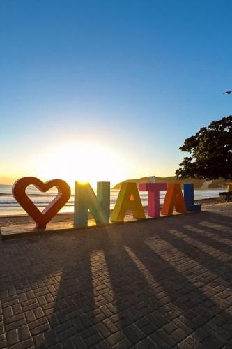 a sign that says love on the beach at Garbos Soleil Hotel in Natal