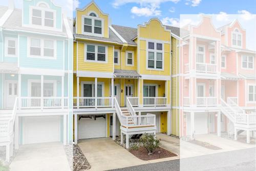 a row of colorful houses in a row at The Wright Stuff OBX in Kill Devil Hills